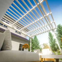 Looking up at white pergola rafters against a blue sky