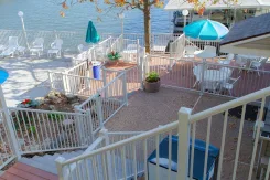 White deck railings around a lakeside pool terrace