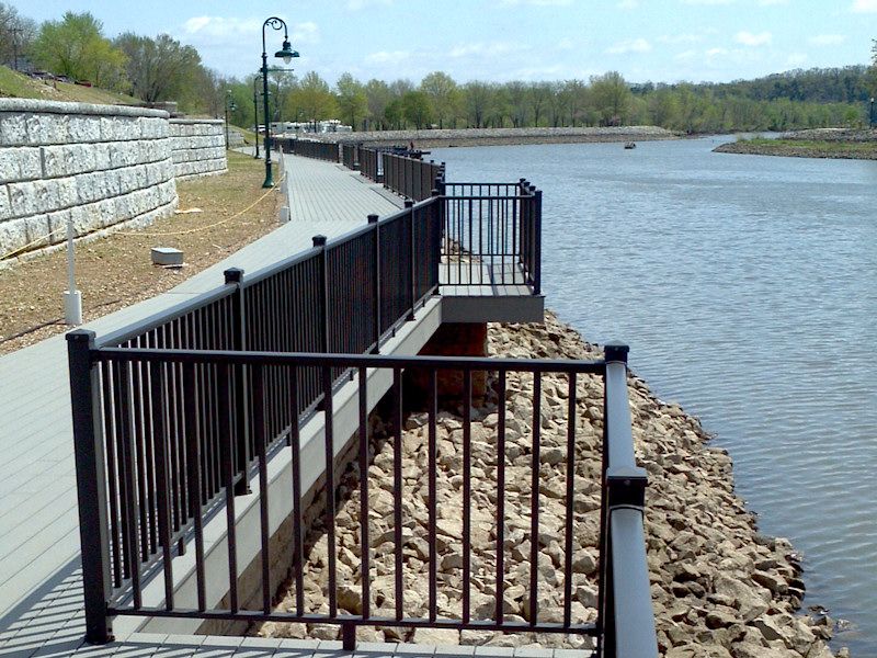 Black metal railings along a waterfront walkway