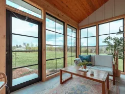 Sunroom interior with a vaulted timber ceiling and countryside views