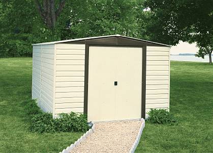 Cream metal garden shed on a lawn with a gravel path