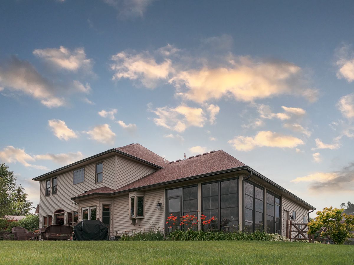 House with a screened porch extension at sunset