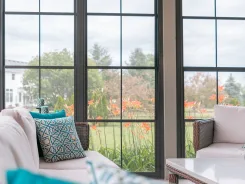 Sunroom interior with colonial grid windows and armchairs
