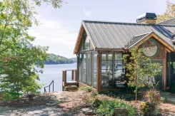 Lakeside sunroom with timber framing and a metal roof