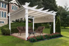 White Monterey pergola with a retractable shade canopy over a patio lounge set