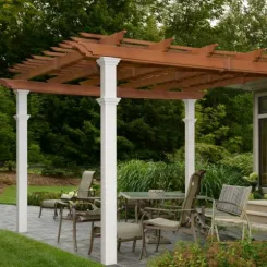 Two-tone pergola with cedar rafters and white columns over a patio dining area