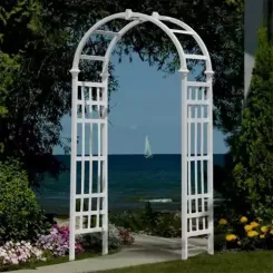 White arched vinyl arbour with lattice sides overlooking a lake