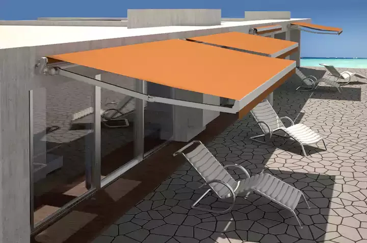 Two orange retractable awnings shading poolside loungers