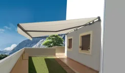 Retractable awning extended over a terrace with a mountain view