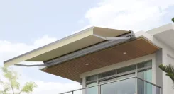 Retractable awning extended from the eaves of a modern house