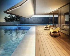 Retractable awning over an indoor pool terrace with loungers