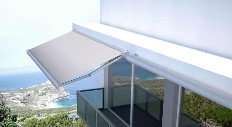 Wide retractable awning extended over a clifftop terrace