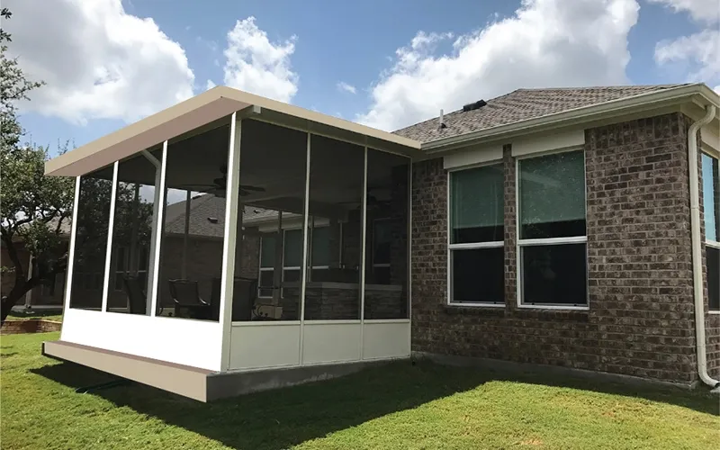 Screen room enclosure attached to a brick house