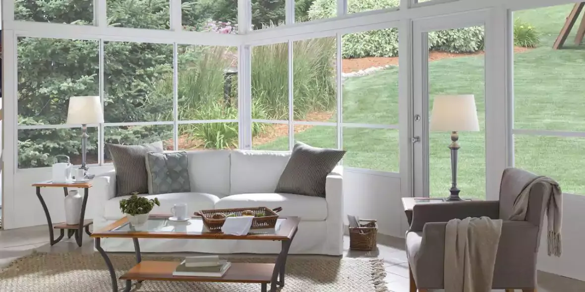 Sunroom interior with sofas, a coffee table and garden views