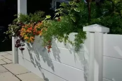 White vinyl planter wall with trailing flowers