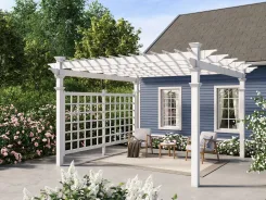 White pergola with a lattice privacy trellis over a patio beside a blue house