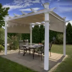 White pergola with a shade canopy over a patio dining set