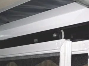 Close-up of a screen room sliding door head and track