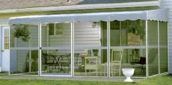 PatioMate screen enclosure with a white scalloped canopy against a sided house