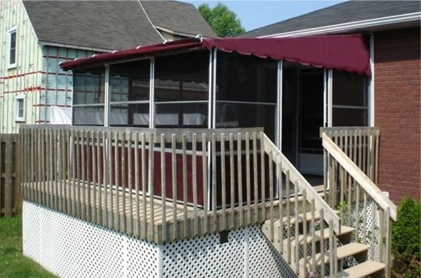Screen room with a burgundy roof on a raised deck with railings and steps