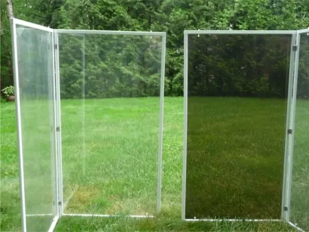 Two clear vinyl window panels standing on a lawn