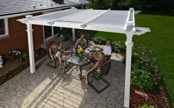 White pergola with translucent roof panels over a family dining on a patio