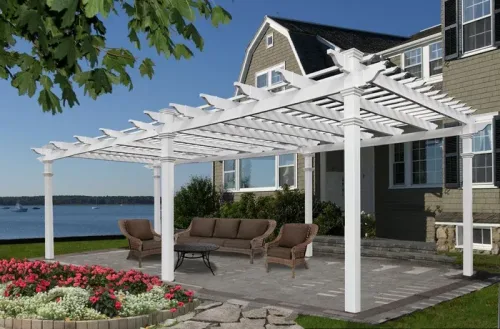 White pergola over a waterfront patio with wicker seating