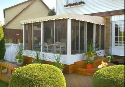 Polaria screen room with a scalloped roof on a deck with planters and shrubs