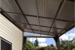 Underside of a Portland patio cover showing the plastic ceiling panels and rafters