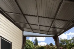 Underside of a Portland patio cover showing the ceiling panels and beam