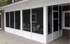 Screened porch with white framed screen walls along the side of a house