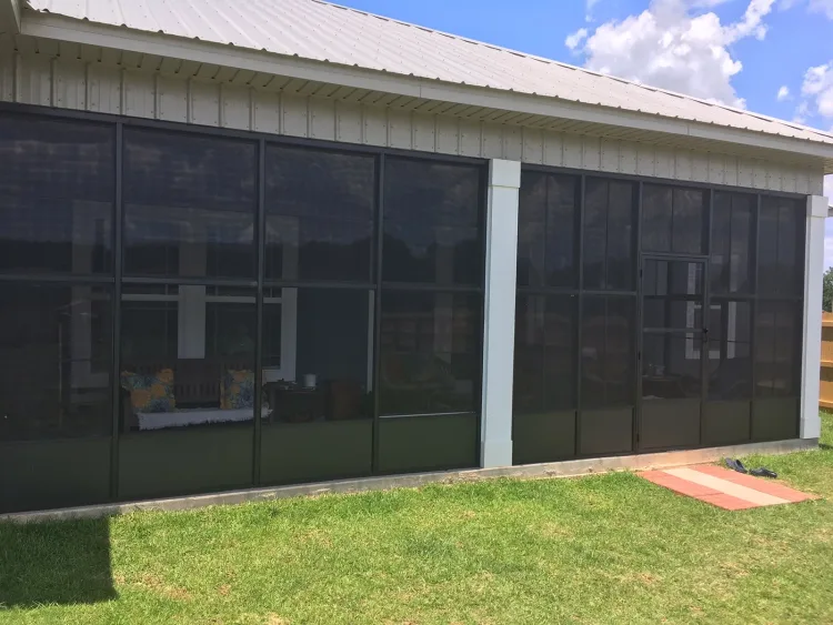 Screen wall system with dark screens along the side of a building