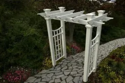 White Fairfield Deluxe arbour with lattice sides on a stone path