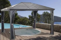 Dark hardtop gazebo beside a swimming pool overlooking a lake
