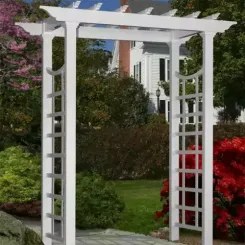 White vinyl arbour with lattice sides and a flat pergola top in a garden