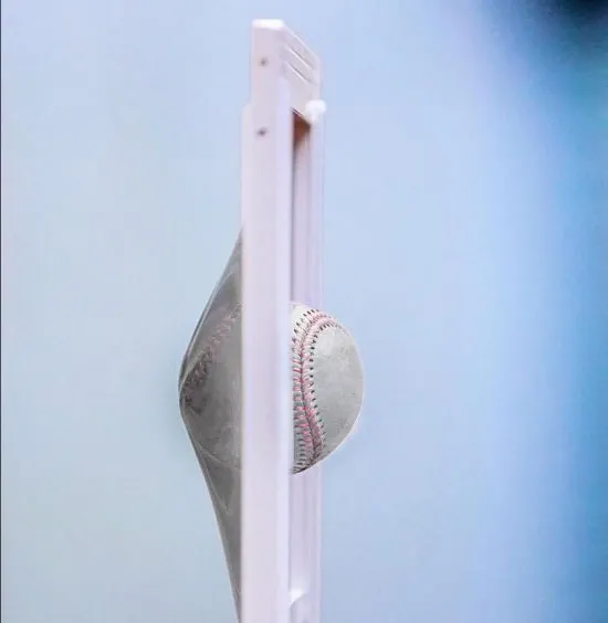 Baseball striking a window panel without breaking it