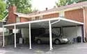 Small photo of a white carport between two houses