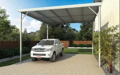 W pan carport over a gravel driveway with a pickup truck